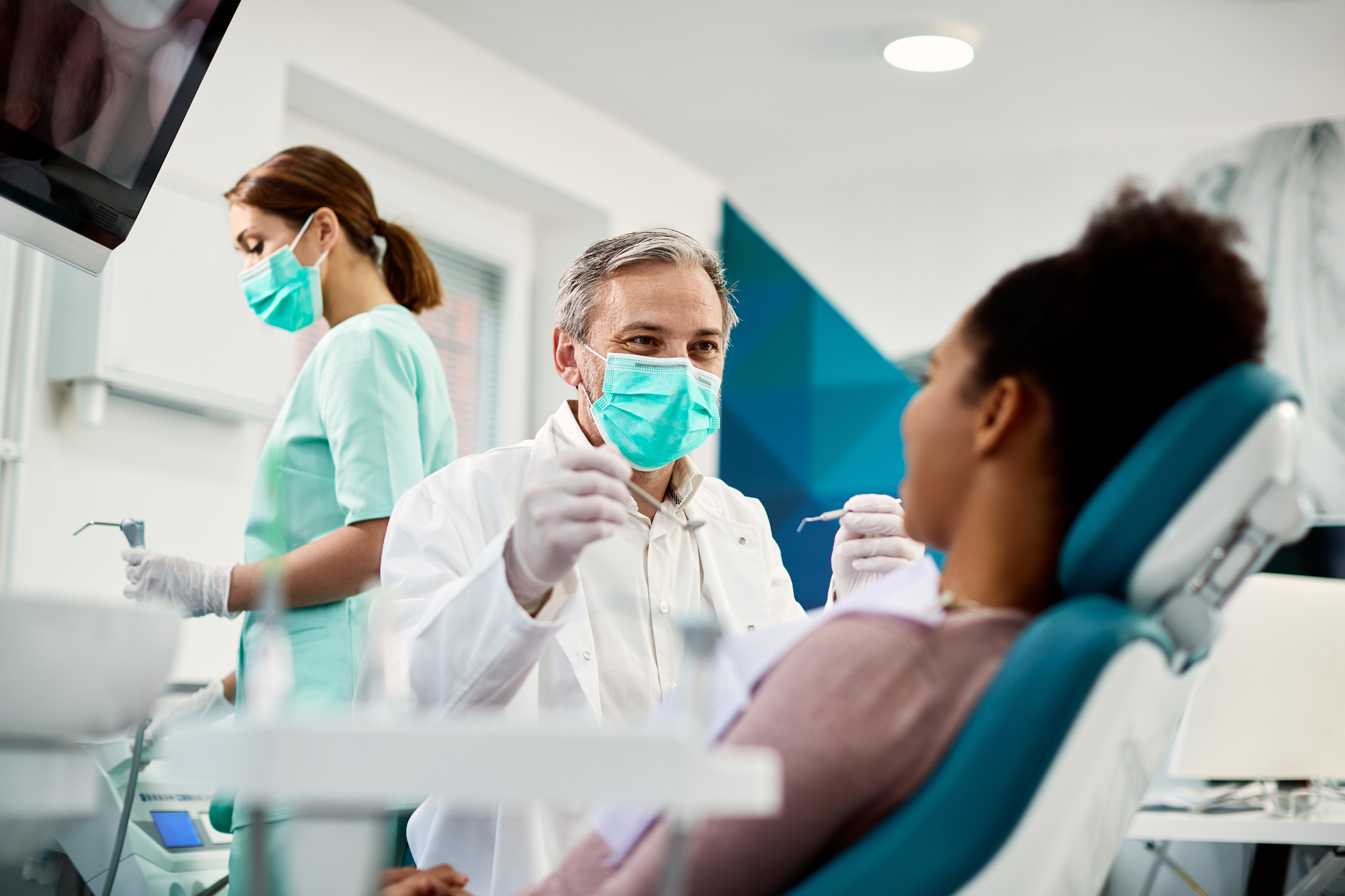 The practice team dental treating patient in chair