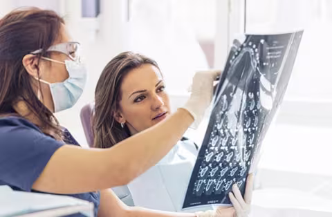 Two clinicians reviewing xray film